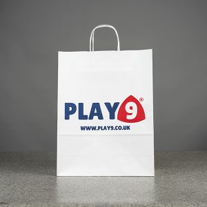 PB Print Printed Paper Bags A close-up of a branded brown paper bag’s handle and logo area, highlighting crisp print details and sturdy construction.